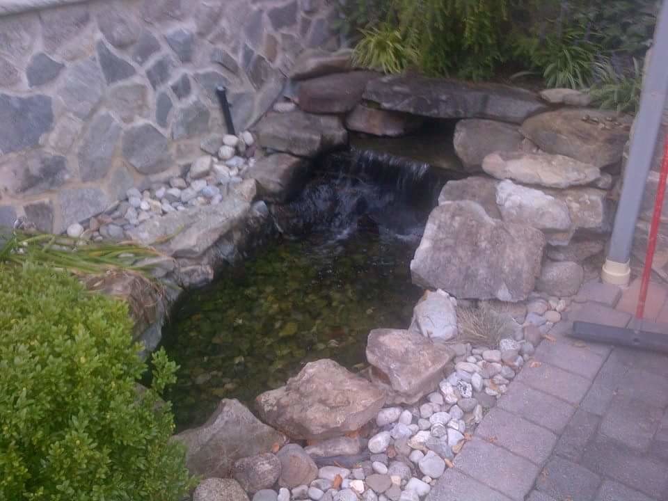 Design ideas for a small traditional backyard brick water fountain landscape in New York.