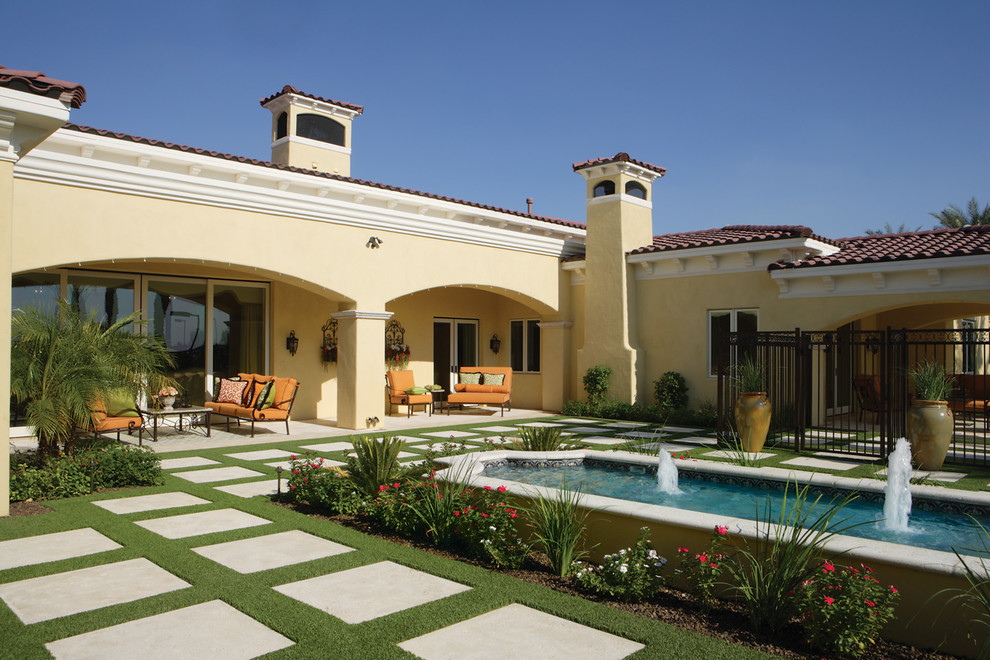 Inspiration for a large mediterranean back full sun garden in Phoenix with a water feature and concrete paving.