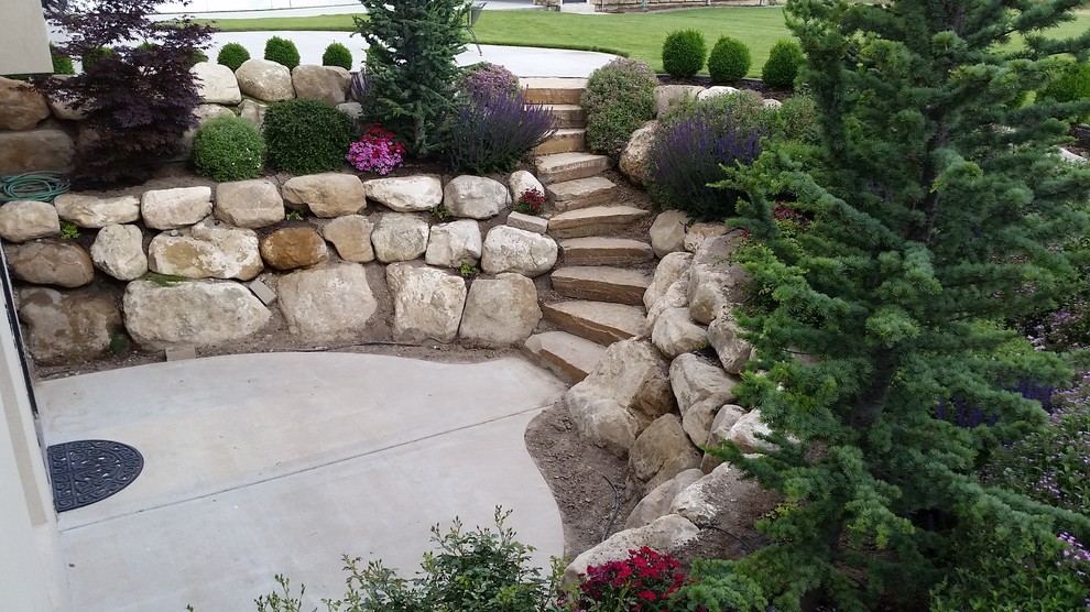 Inspiration for a mid-sized traditional partial sun backyard retaining wall landscape in Salt Lake City.