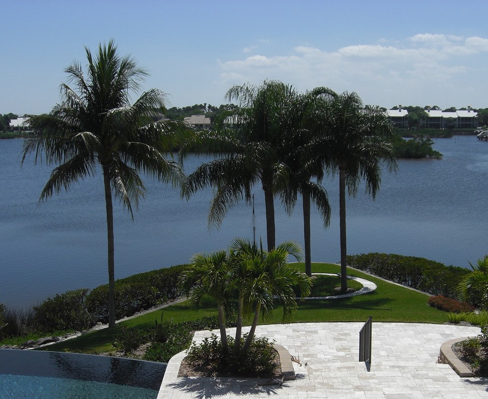 This is an example of a large mediterranean full sun backyard stone formal garden in Miami.