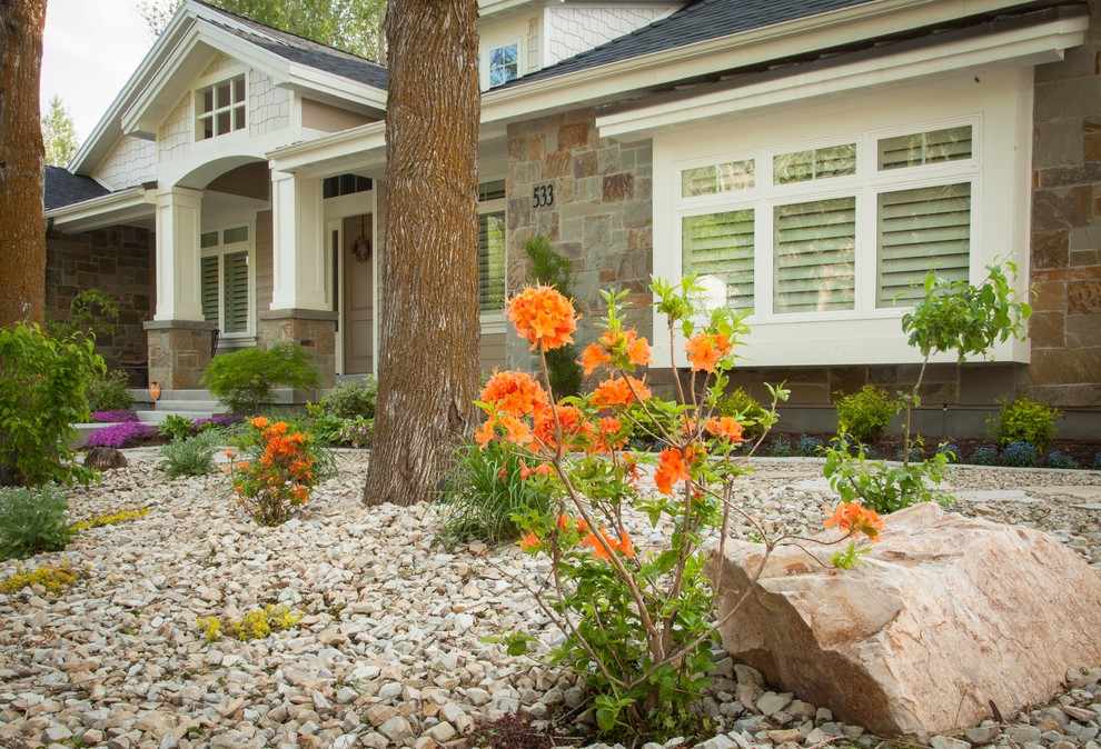 This is an example of a large traditional drought-tolerant and full sun front yard gravel landscaping in Salt Lake City for spring.