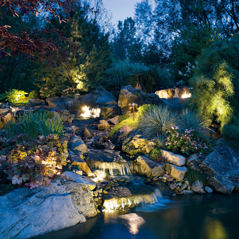 Inspiration for a large transitional backyard stone pond in Detroit.