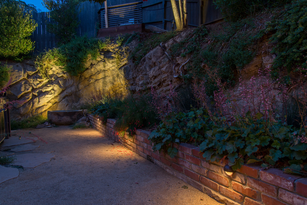 Design ideas for a small modern drought-tolerant and partial sun backyard retaining wall landscape in Los Angeles for spring.