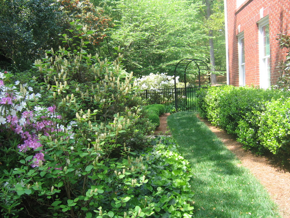 Inspiration for a large contemporary sloped formal full sun garden in Atlanta with a garden path and mulch.