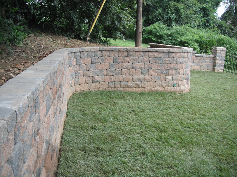 This is an example of a large backyard brick retaining wall landscape in Philadelphia.