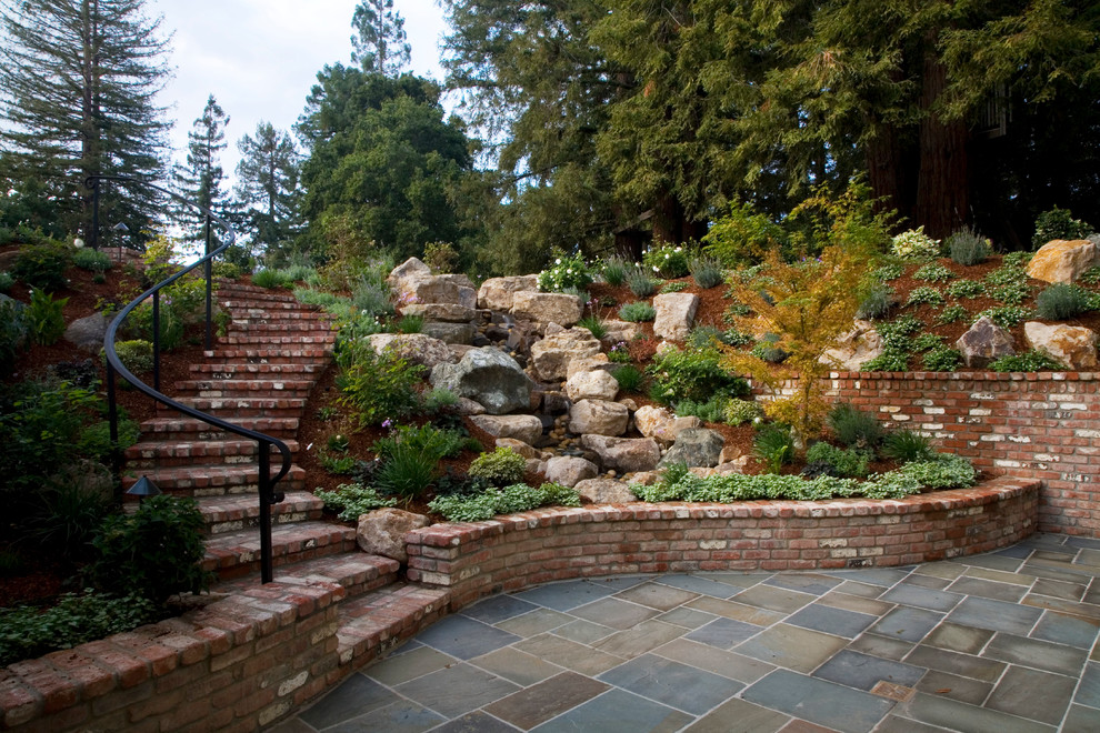 Inspiration for a large traditional full sun hillside mulch landscaping in San Francisco.