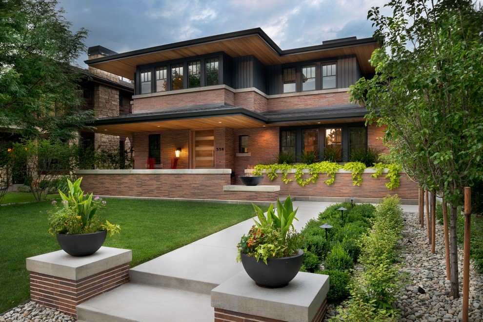 Photo of a medium sized modern front formal garden in Denver with a potted garden and concrete paving.