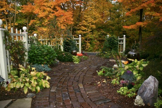 Photo of a large traditional full sun backyard stone landscaping in Other.