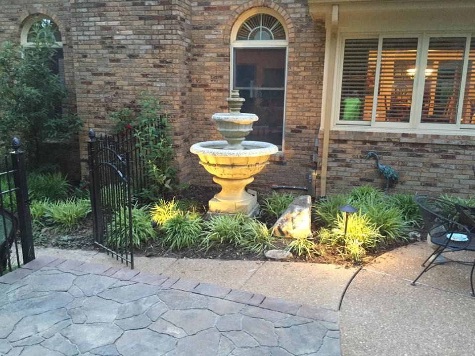 Inspiration for a medium sized mediterranean back partial sun garden in St Louis with a water feature and concrete paving.