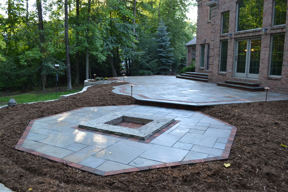 Lannon stone fire pit in a Bluestone patio Traditional Landscape