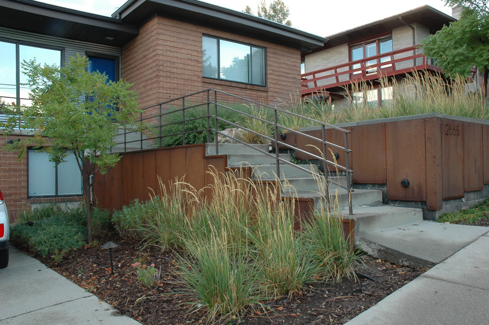 Photo of a mid-sized modern drought-tolerant and full sun front yard retaining wall landscape in Salt Lake City for fall.