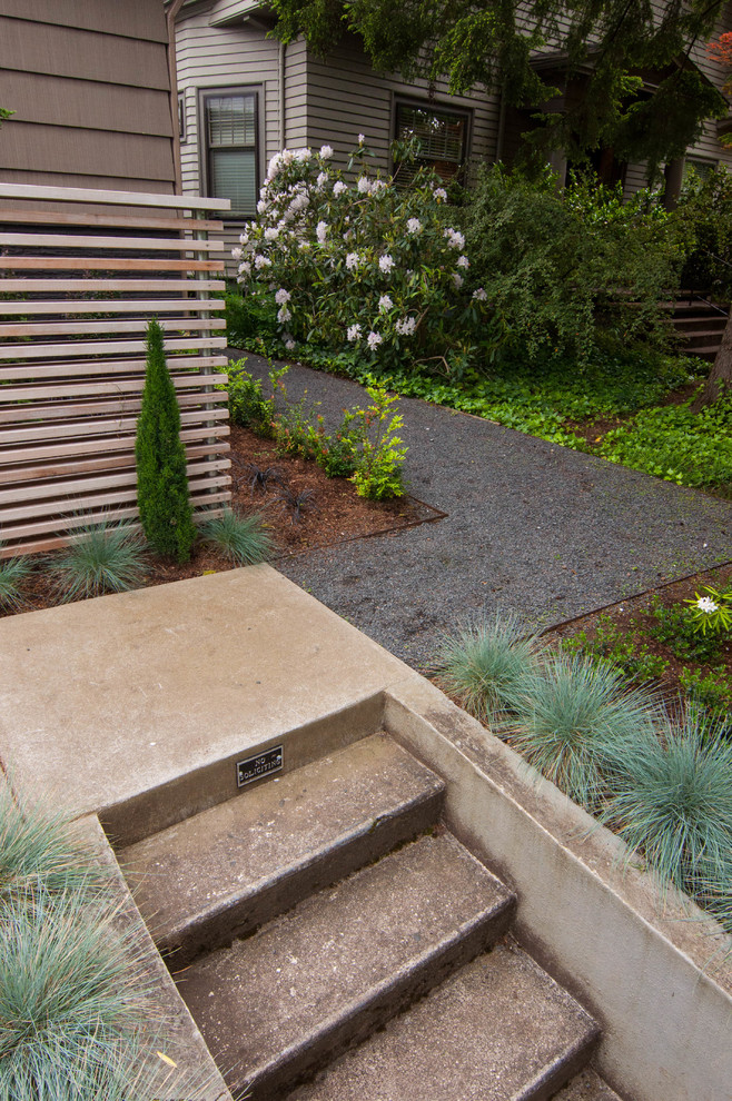 This is an example of a small midcentury front formal partial sun garden for winter in Portland with a garden path and gravel.