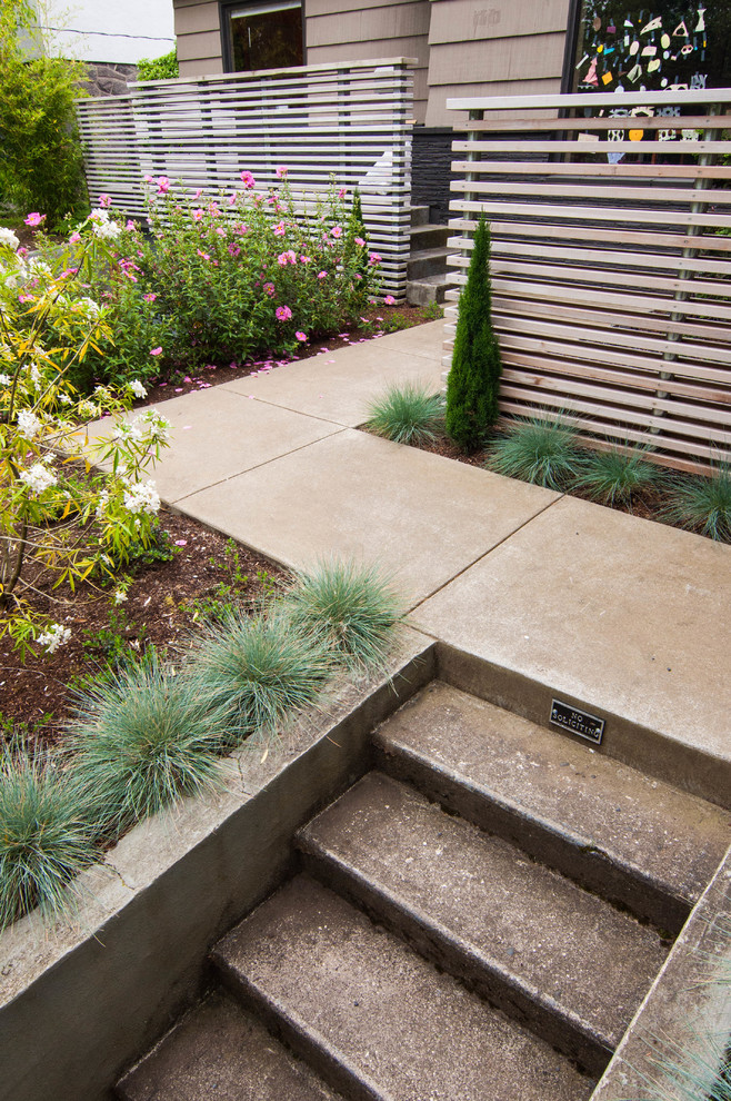 Design ideas for a small mid-century modern partial sun front yard concrete paver landscaping in Portland for winter.