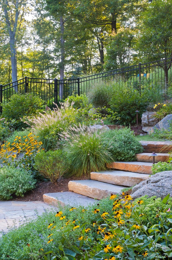 Inspiration for a mid-sized traditional partial sun backyard stone landscaping in New York.