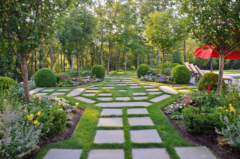 Photo of a large traditional partial sun backyard concrete paver formal garden in New York.