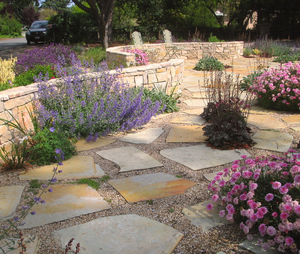 Photo of a mid-sized mediterranean partial sun backyard stone landscaping in San Francisco.