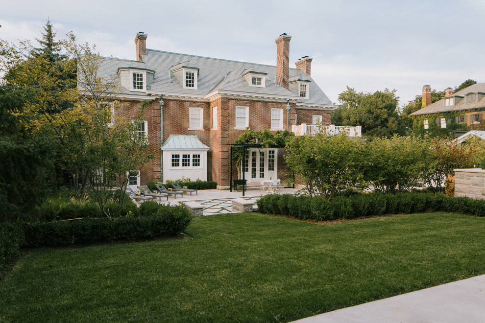 This is an example of a large classic back formal garden in Toronto with lawn edging.