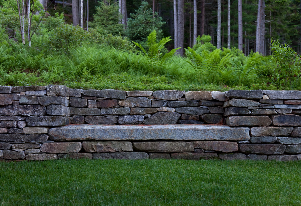 Rustic garden seating in Boston with a retaining wall.