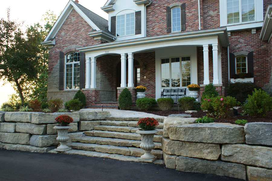Photo of a medium sized contemporary front partial sun garden in St Louis with a retaining wall.