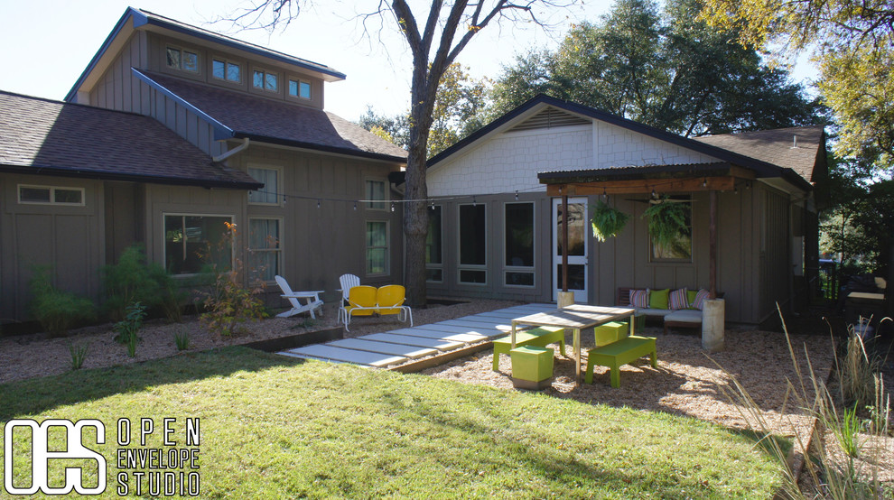 Photo of a small modern back full sun garden in Austin with a retaining wall and concrete paving.
