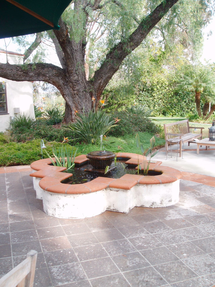 Inspiration for a mediterranean back patio in San Diego with a water feature.