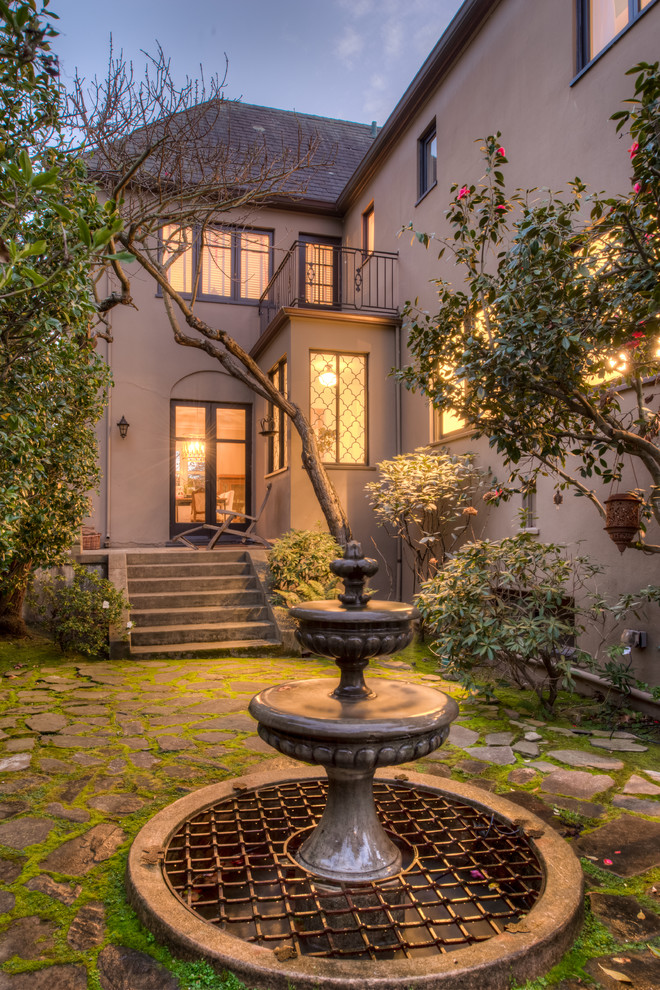 This is an example of a classic garden in San Francisco with a water feature and natural stone paving.
