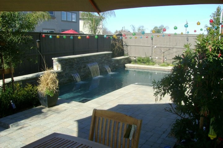 This is an example of a mediterranean backyard water fountain landscape in Sacramento.