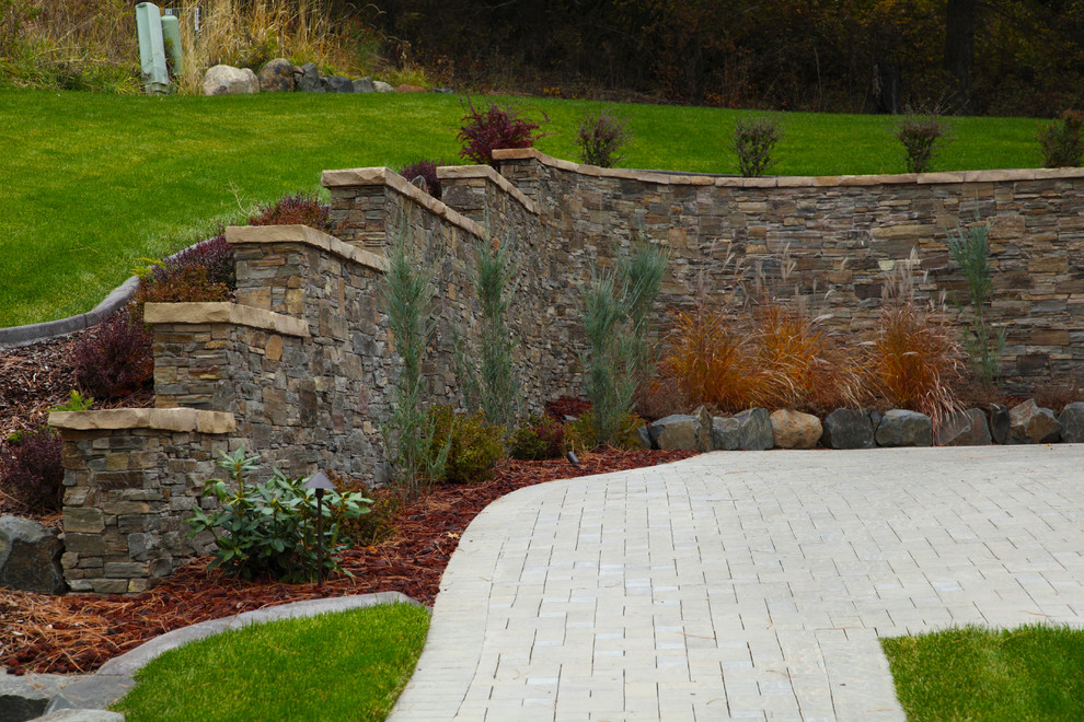 Inspiration for a large craftsman front yard stone landscaping in Seattle.