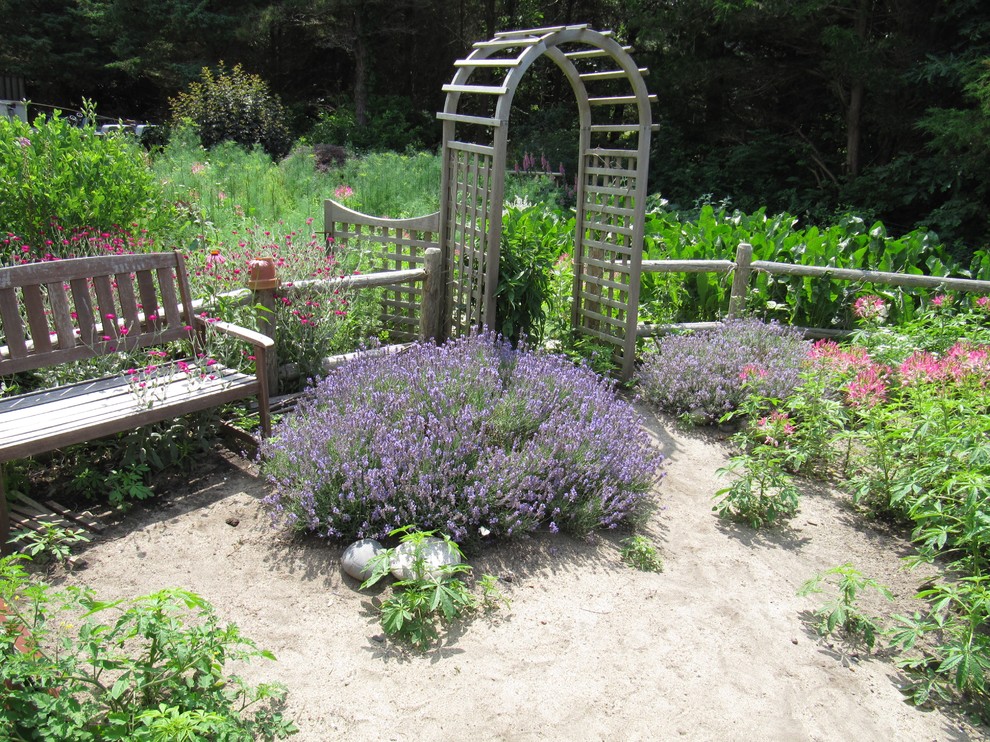Photo of a large traditional back formal full sun garden for summer in Boston with a vegetable patch and mulch.