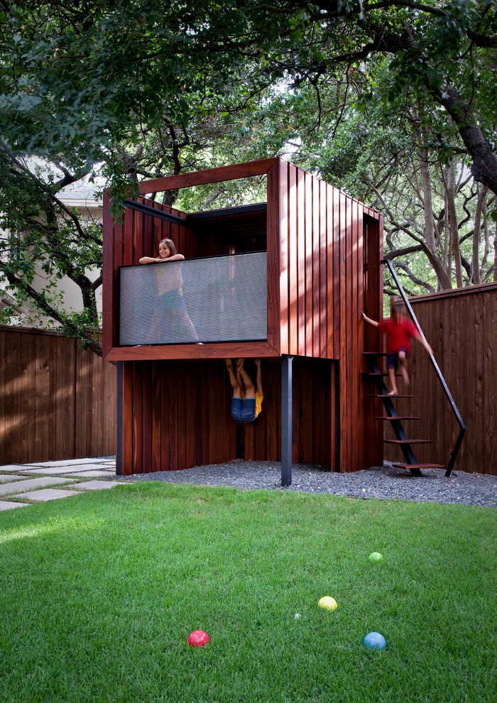 This is an example of a mid-sized contemporary backyard outdoor playset in Austin.