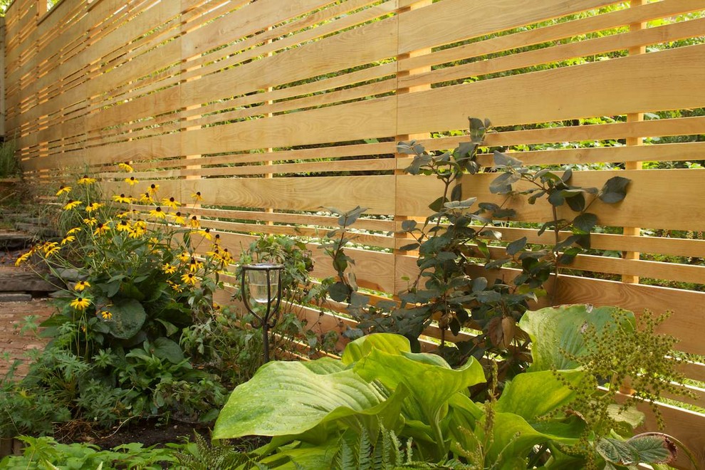 This is an example of a small modern shade backyard brick garden path in New York for spring.