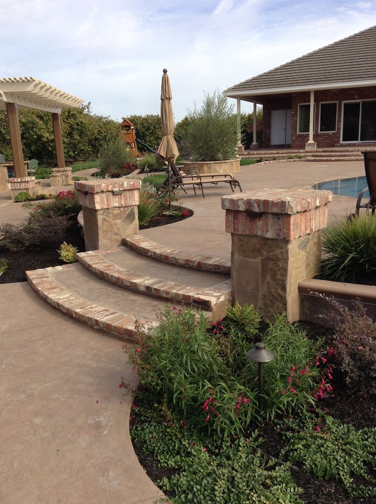 Design ideas for a rustic back full sun garden in Sacramento with a garden path and brick paving.