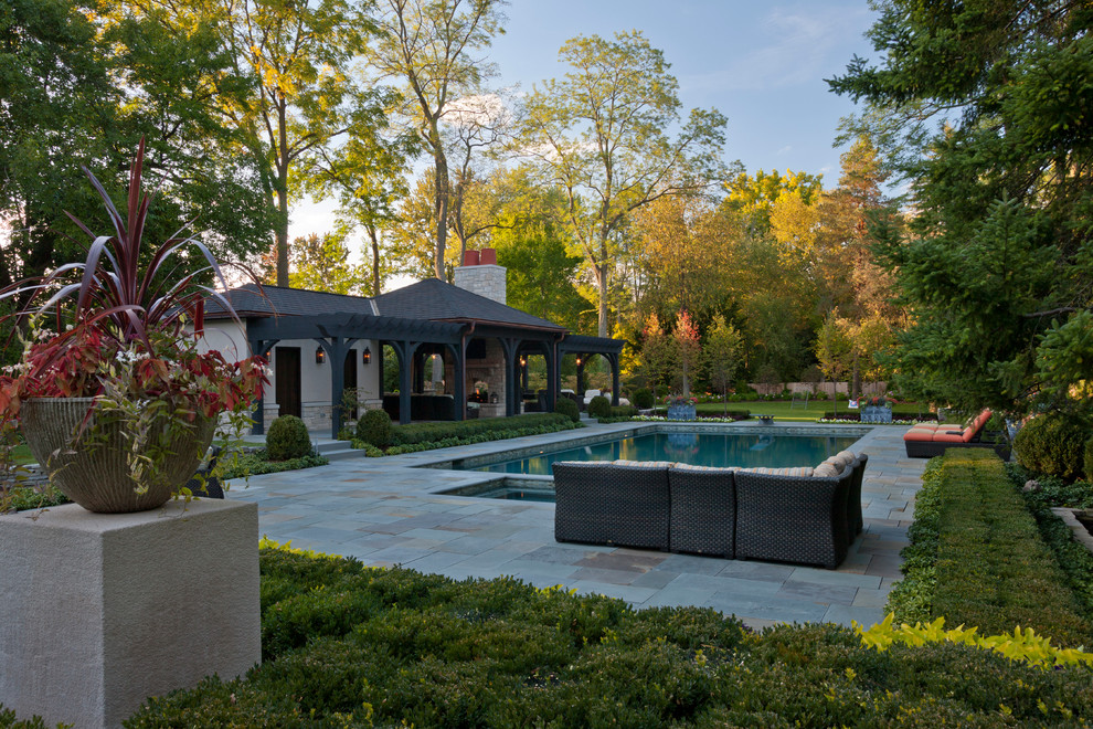 Imagen de jardín clásico renovado de tamaño medio en patio trasero con adoquines de piedra natural