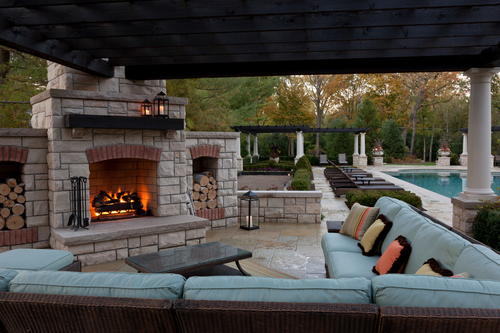 Inspiration for a large classic back patio in Detroit with natural stone paving.
