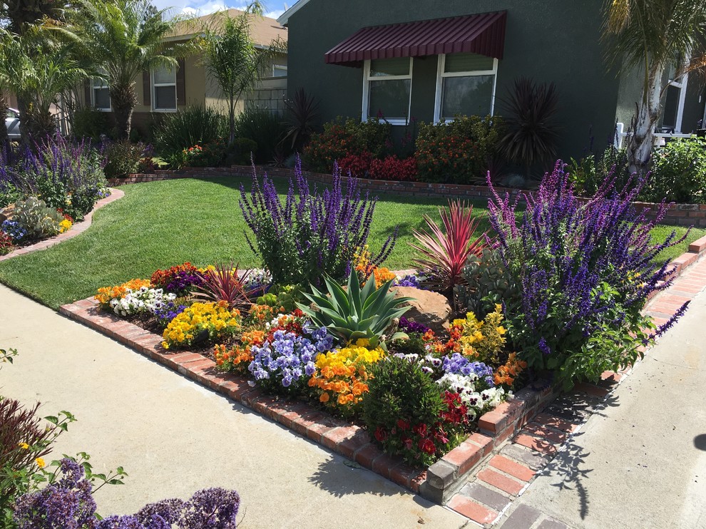 Inspiration for a mid-sized mediterranean full sun front yard brick landscaping in Orange County for summer.