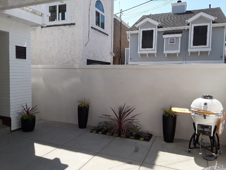 Foto di un piccolo giardino design esposto in pieno sole dietro casa con un focolare e pavimentazioni in cemento