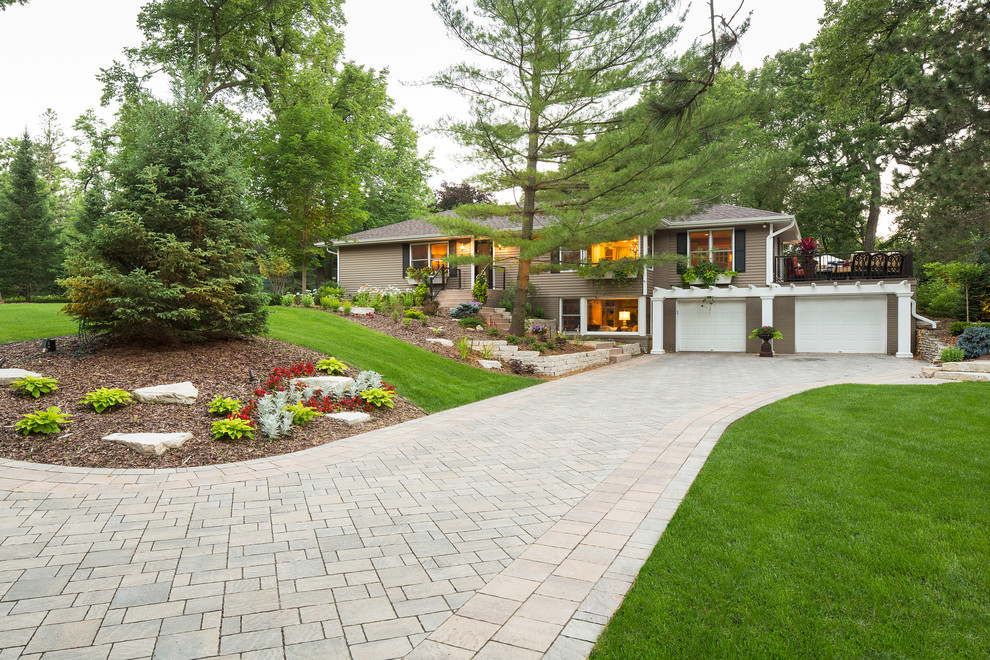 Photo of a large traditional full sun front yard brick driveway in Minneapolis.