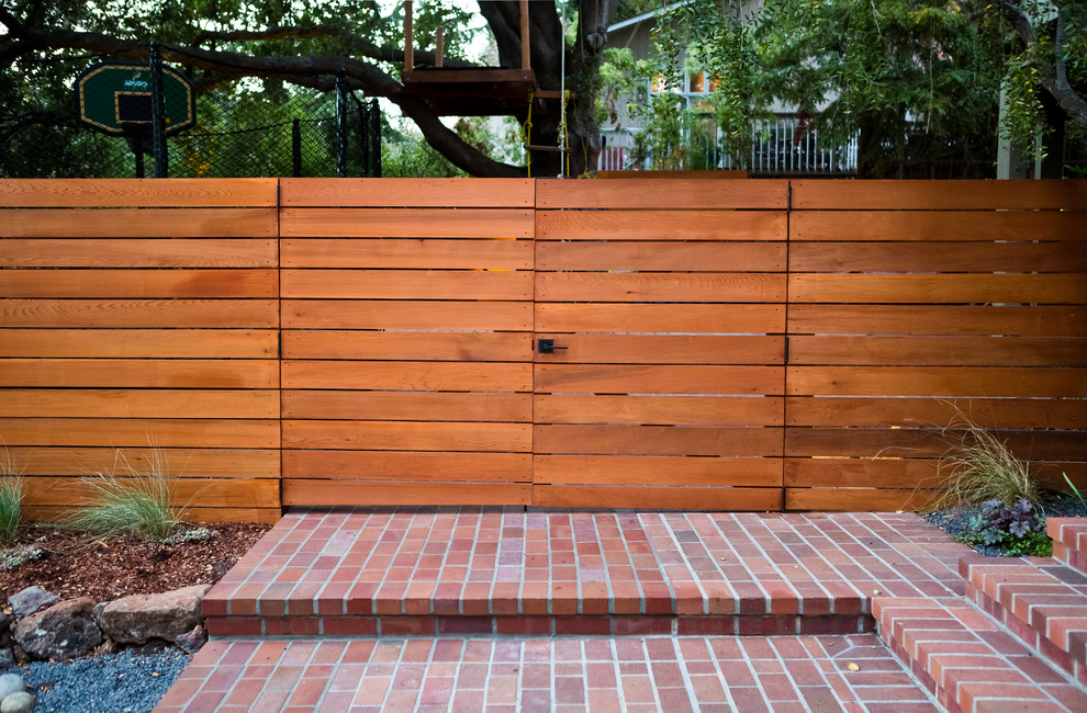 This is an example of a mid-sized modern drought-tolerant and partial sun front yard brick garden path in San Francisco.