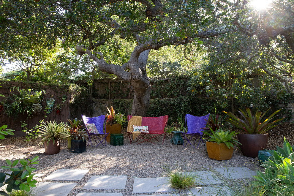 Example of a large trendy side yard gravel patio design in Santa Barbara with a fire pit