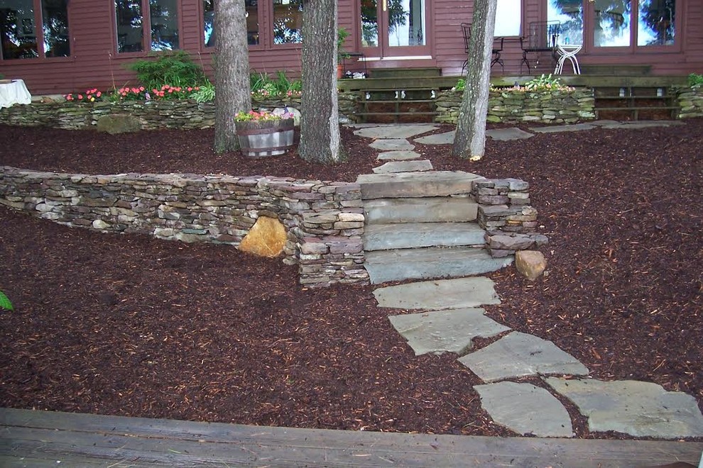 Photo of a mid-sized traditional partial sun backyard stone garden path in Portland Maine.