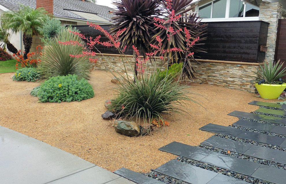Inspiration for a small transitional full sun front yard stone garden path in Orange County for summer.
