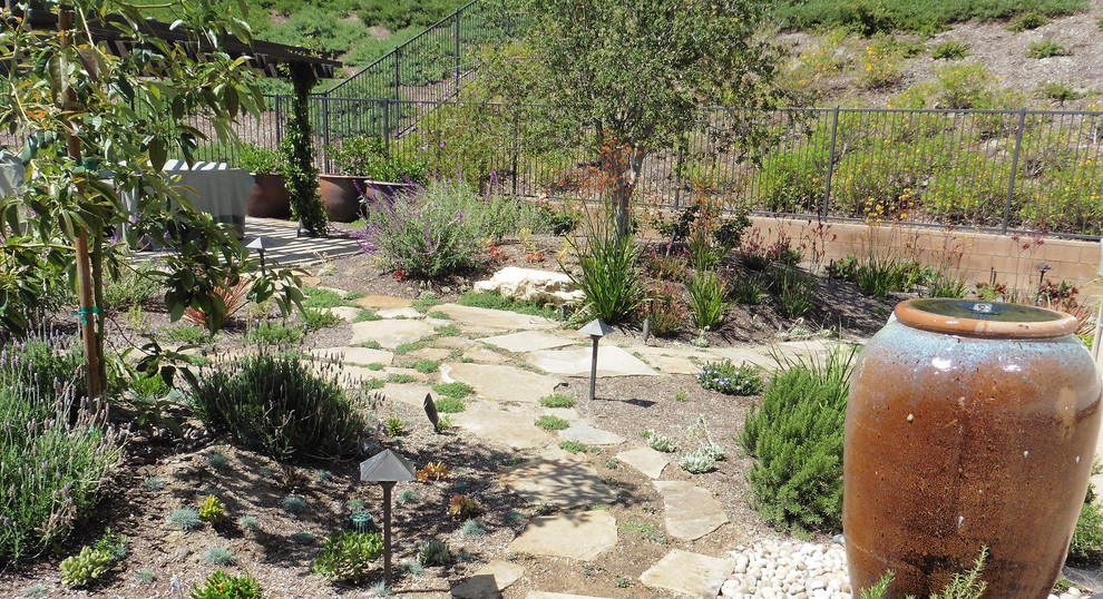 Design ideas for a large transitional full sun backyard stone landscaping in Orange County for summer.