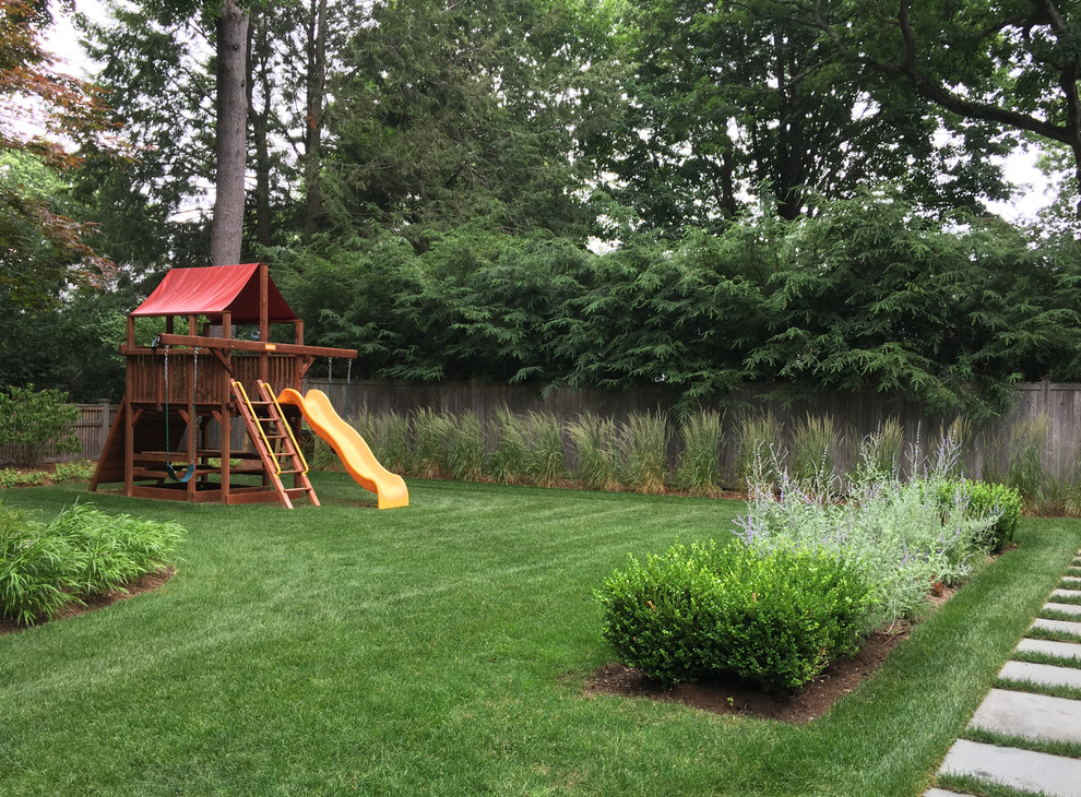 This is an example of a mid-sized transitional partial sun backyard outdoor playset in Boston.