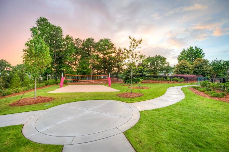 This is an example of an expansive classic back formal garden in Atlanta with a climbing frame and concrete paving.