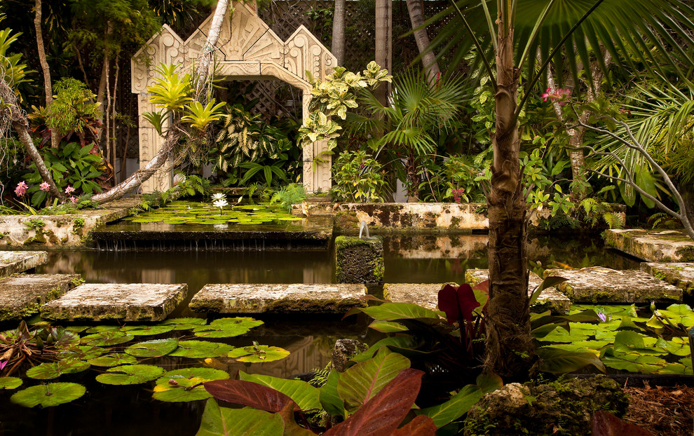 Design ideas for a small tropical partial sun courtyard stone water fountain landscape in Miami.