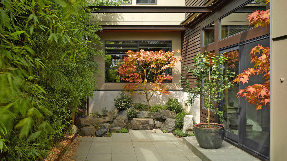Foto di un giardino minimalista esposto a mezz'ombra nel cortile laterale con pavimentazioni in pietra naturale