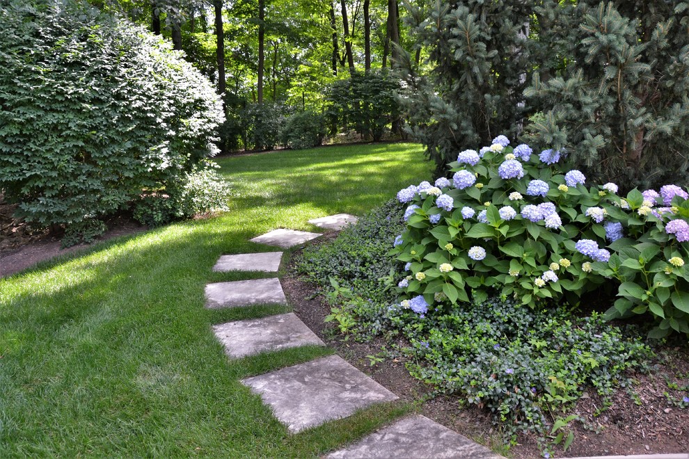 This is an example of a small eclectic partial sun backyard concrete paver landscaping in New York.