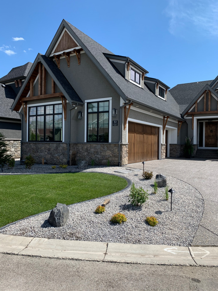 Design ideas for a large coastal drought-tolerant, desert and full sun front yard stone landscaping in Calgary.