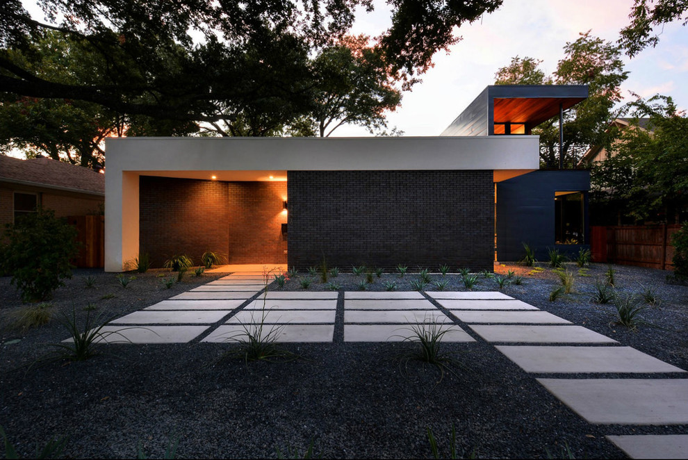 Photo of a medium sized modern back xeriscape garden in Austin with gravel.