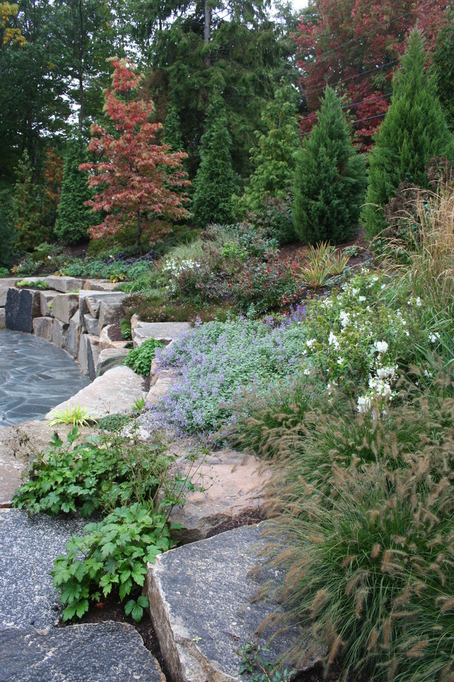 Cette image montre un jardin chalet l'automne avec une pente, une colline ou un talus et des pavés en pierre naturelle.